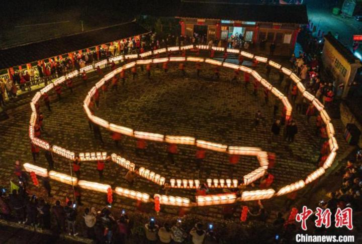 村民们舞起自制的烛桥，以独特的方式举行“迎烛桥”民俗活动。　张凌欣 摄